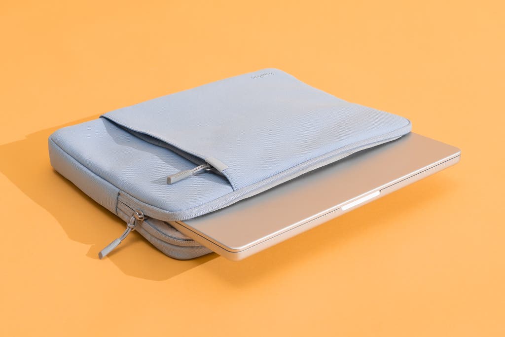 The Defender A13 sleeve with a laptop poking out from its opening.